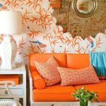 tangerine colored couch, cushions, wallpaper